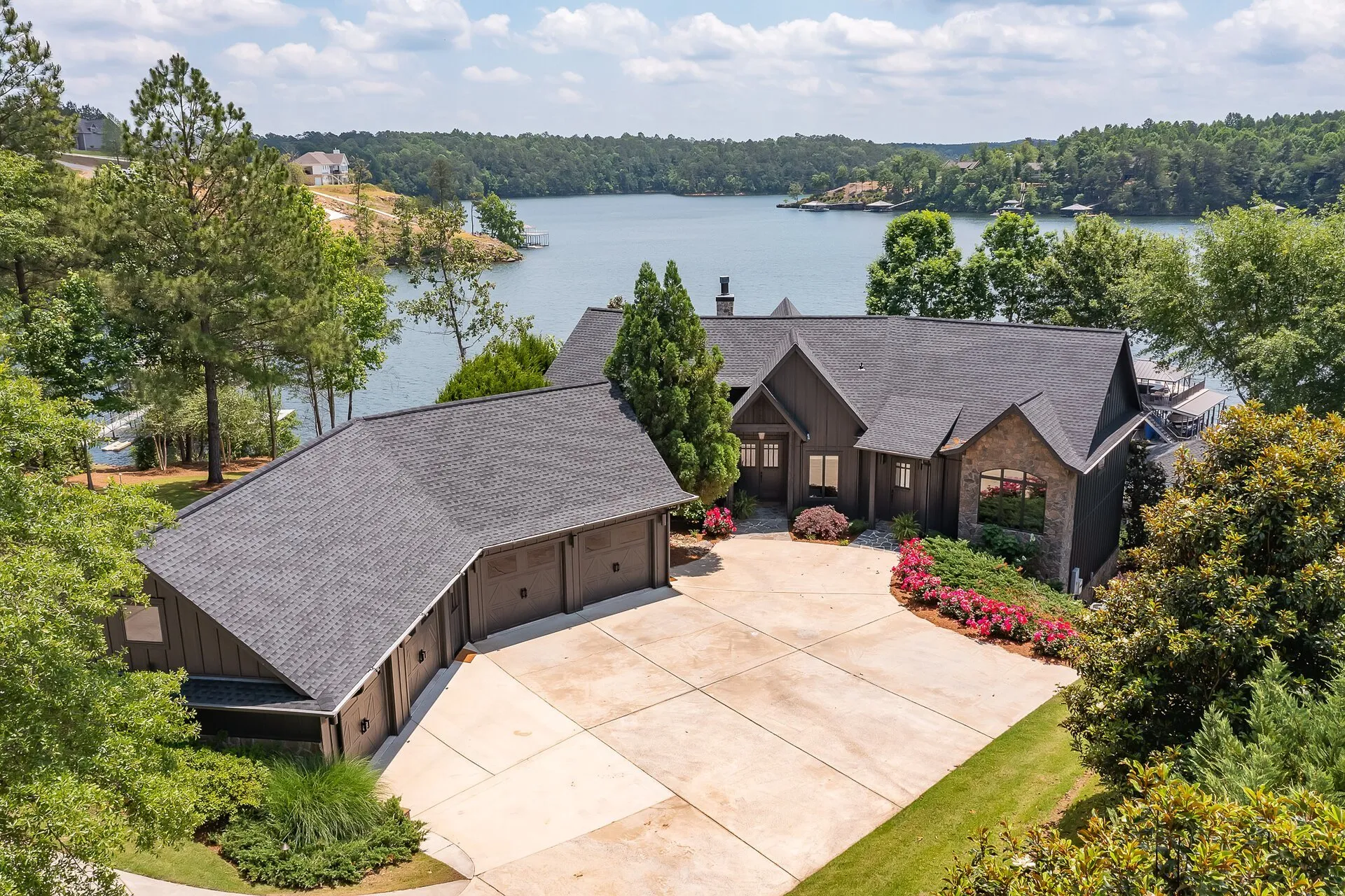 Aerial drone view of a lakefront property showing lot size and neighborhood context